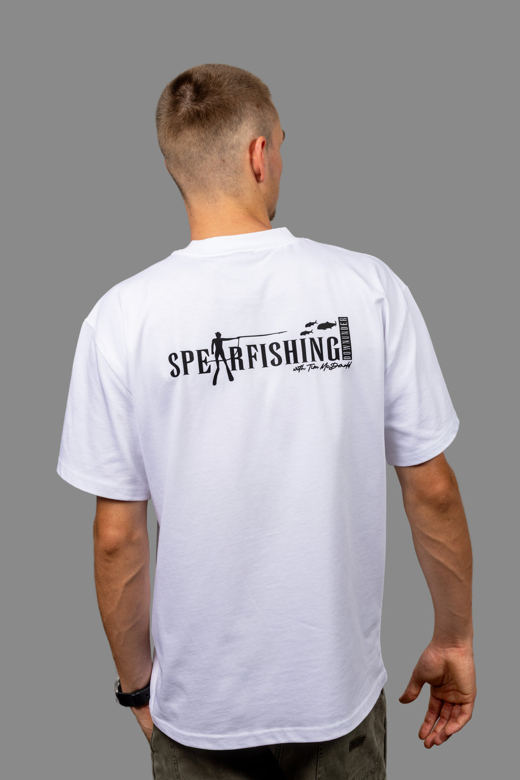 Person wearing a white t-shirt with 'Spearfishing' text on the back against a gray background